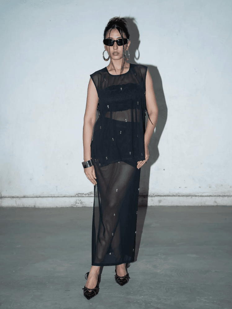 Image may contain Clothing Dress Evening Dress Formal Wear Footwear Sandal Adult Person Fashion and Standing