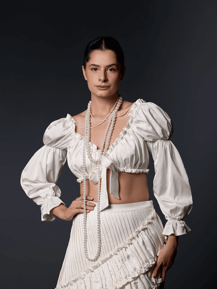 Image may contain Blouse Clothing Adult Person Accessories Jewelry Necklace and Fashion